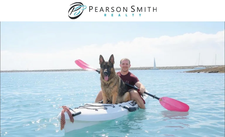 Pearson Smith Realty logo above a bright photo of Realtor Kyle Bond kayaking with his dog